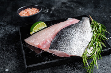 Wall Mural - Uncooked Raw Dorado Sea bream fish fillets. Black background. Top view