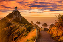 Nugget Point Lighthouse And The Nuggets, Otago,  A Famous Sight On The East Coast Of New Zealand.