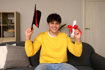 Poster - Male graduate student with diploma video chatting at home