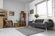 © Pixel-Shot - Modern interior of living room with grey sofa and wooden furniture