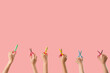 © Pixel-Shot - Many hands with paper scissors on pink background