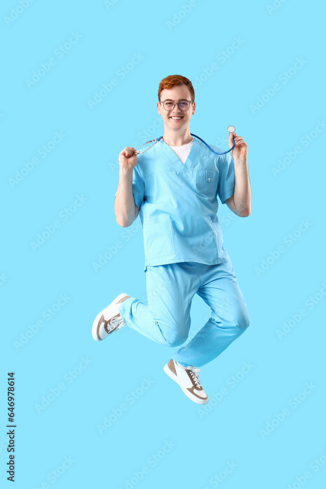 Jumping male nurse on blue background