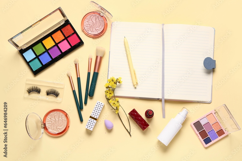 Composition with makeup cosmetics, beautiful flowers and notebook on beige background