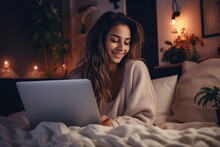 young woman in comfortable clothes working with her laptop from home