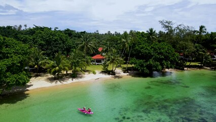 Wall Mural - a couple of men and women in a kayak on the tropical island Koh Chang Thailand, drone view at the kayak. 