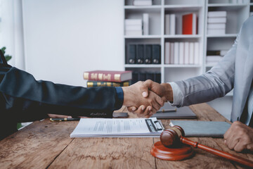 Wall Mural - Businessman handshake to seal a deal with his partner lawyer or attorney discussing a contract agreement.