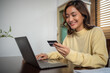 © tuiphotoengineer - Women using Smart phone and Laptop for shopping online and payment with Credit card at home