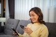 © tuiphotoengineer - Women using Smart phone and Laptop for shopping online and payment with Credit card at home