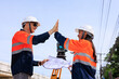 © SHUTTER DIN - engineer and surveyor engineers high five after work at road construction site, angle shot