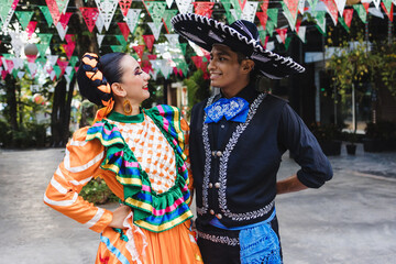 Wall Mural - Latin couple of dancers wearing traditional Mexican dress from Mexico Latin America, young hispanic woman and man in independence day, parade or cultural Festival 