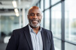 © Chrysos - A Smiling Black Middle Aged Business or Corporate Leader in the office