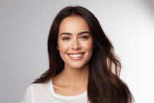 Closeup Photo Portrait Of A Beautiful Young Latin Hispanic Model Woman Smiling With Clean Teeth. Used For A Dental Ad. Isolated On Light Background.