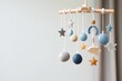 Baby crib mobile with stars, planets and moon. Kids handmade toys above the newborn crib. First baby eco-friendly toys made from felt and wood. Generative AI