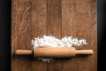 Wall Mural - Rolling pin and flour on wooden board