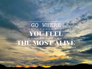 Life travel inspirational motivational quote - Go where you feel the most alive with blurred nature background.


