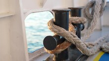 Close Up Of Nautical Rope With Sailing Knot On The Bitts For Boating And Mooring Vessel. 