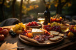 Autumn Picnic Bliss: A picnic spread featuring a charcuterie board, cheese, and seasonal fruits, arranged on a cozy blanket amidst the colorful autumn foliage...