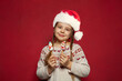 © millaf - Christmas child Santa smiling on red background