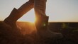 © maxximmm - farmer feet walks across a lifestyle black field. agriculture business concept. silhouette of a farmer feet at sunset walking across a black plowed field. farmer in rubber boots legs close-up