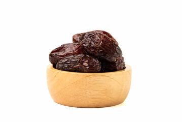 Wall Mural - Heap of dried dates in wooden bowl isolated on white background.
