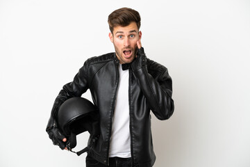 Wall Mural - Young caucasian man with a motorcycle helmet isolated on white background with surprise and shocked facial expression