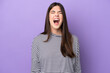 © luismolinero - Young Brazilian woman isolated on purple background shouting to the front with mouth wide open