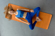 © Denys Kurbatov - Flexible athletic girl in blue sport clothes exercising on yoga mat