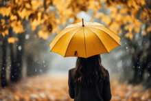 Back View Of Charming Woman With Yellow Umbrella On Autumn Rainy Day. Generative AI