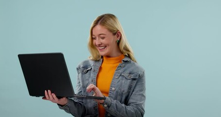 Woman, student and winner on laptop for university success, college results or funding opportunity in studio. Young person yes, fist and celebration on computer for education news on blue background