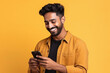 © Niks Ads - Young man using smartphone and smiling