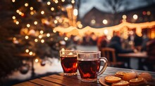 Two Glasses Of Mulled Wine On The Table, Blur Christmas Market Bokeh Lights Background