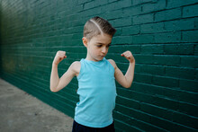 Guns - Cool Young Australian Boy Wearing A Singlet With A Crew Cut Flexing His Bicep Muscles