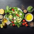 Plate with healthy green salad with lettuce, avocado, nuts and olive oil salat dressing with lemon, top view