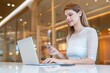 © StockPhotoRepublic - Young caucasian woman doing digital banking using her laptop and credit card online in a random cafe