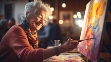 Senior Woman Painting On A Canvas, Showcasing Her Artistic Talents