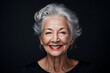 © IgnacioJulian - Graceful Older Woman Smiling Against a Gray Background with Bold Elegance, Distinctive Facial Features, and Sterling Silver Highlights