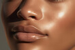 © Екатерина Ракунова - Close up of beautiful lips. Perfect black skin and plump lips with natural makeup. Part of face. Highlighter, shimmer, bronzer. Make up concept.  Beautiful African-American woman.