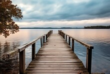 A Wooden Dock Sitting Next To A Body Of Water