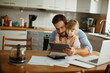 © Geber86 - Young Caucasian father and daughter using a tablet in the kitchen in the morning