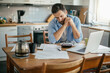 © Geber86 - Worried young Caucasian man going over his bills and home finances in the morning in the kitchen