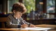 © Studio Nova - Little boy draws sitting at a table