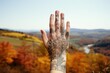 © irissca - Autumn tattoo ideas. Hand with thin line monochrome tattoo of autumn landscape background