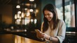 © yj - Happy woman browsing social media on her smartphone in cafe. generative AI