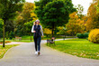 Healthy lifestyle - woman walking in city park
