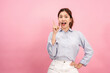 © Katcha - Young asian woman wearing long sleeve shirt and using hands with forefingers to pointing advertisement
