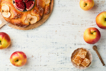 Wall Mural - Jewish Holidays - Rosh Hashanah or Rosh Hashana. Pomegranate, apples, honey and round challah on old wooden white table background. Jewish Autumn celebration. Shana Tova. Yom kippur concept. Top view