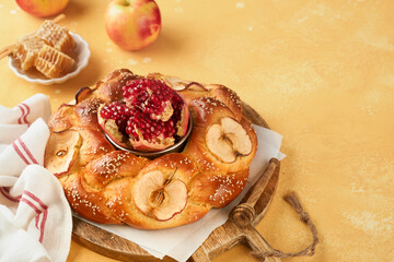 Wall Mural - Jewish Holidays - Rosh Hashanah or Rosh Hashana. Pomegranate, apples, honey and round challah on rustic yellow table background. Jewish Autumn celebration. Shana Tova. Yom kippur concept. Top view.