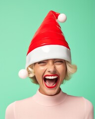 Wall Mural - A beautiful portrait of a smiling woman wearing a festive red santa hat radiates joy and hope for the new year, bringing a sense of pastel warmth and holiday cheer
