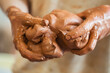 © Raquel - Detail of a ceramist woman's hands molding the clay