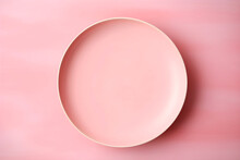 Empty ceramic pastel pink plate on pastel pink tabletop background, top view